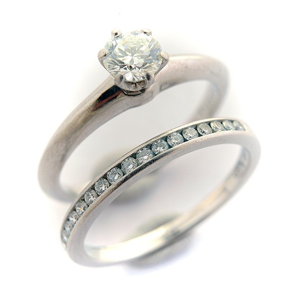 Tiffany & Co. Diamond, Platinum Wedding Ring Set.: Tiffany & Co. Diamond, Platinum Wedding Ring Set. Including one round brilliant-cut diamond weighing approximately 0.55 ct., platinum engagement ring together with a diamond, platinum band featuring s
