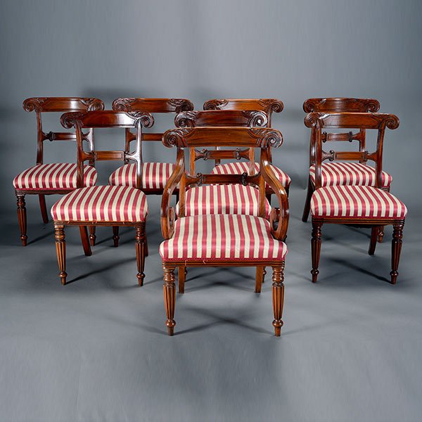 Eight Regency Style Mahogany Chairs: Eight Regency Style Mahogany Chairs, Each with twist turned and molded crestrails, adorned by knurl form rosette medallions, over a horizontal splat, flanked by scroll ends, above a cream and wine str