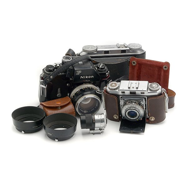 Three Vintage Cameras: Three Vintage Cameras: Comprising Voigtlander Bessa II folding camera; a Nikon F with 50mm 1:14 non ai lens, and two attachments; Zeiss Ikon Contina folding camera; and an Acall zoom finder (4)