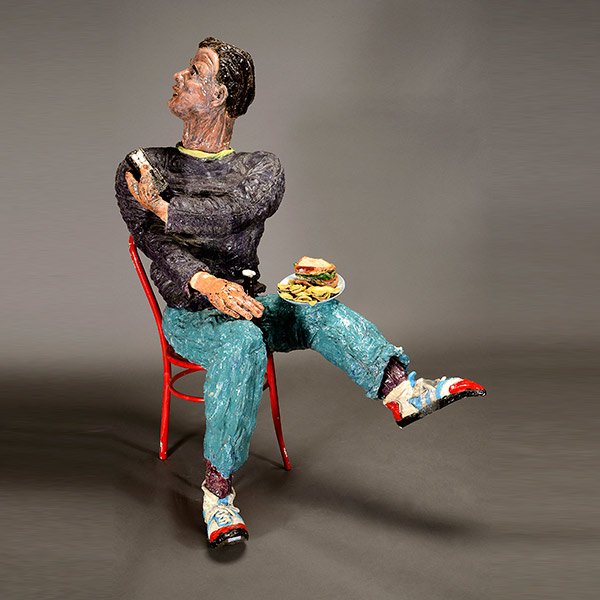 TONY NATSOULAS Funk Art Ceramic Sculpture: TONY NATSOULAS (Californian, born 1959) "Man with Bud Light and Remote Control" (Man looking up to his right (presumably at a TV) holding a remote control and balancing a plate with a sandwich and pot