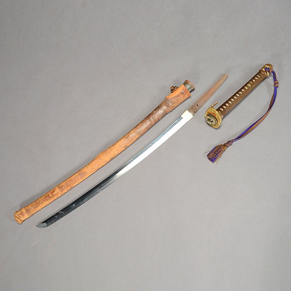 A World War Two Japanese Shin Gunto Sword: A World War Two Japanese Shin Gunto Sword Type 94 officer's sword issued in 1934, with ray skin and silk wrapped hilt, cherry blossom theme gilt-painted cast iron tsuba, fuchi and menuki. {Length: 25