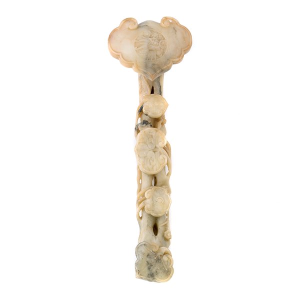A Soapstone Ruyi Scepter: A Soapstone Ruyi Scepter Designed with lingzhi issuing from the curving branch-form handle, two carved with fruit decorations, the large terminal carved with a dragon medallion. {Length: 15 inches (38