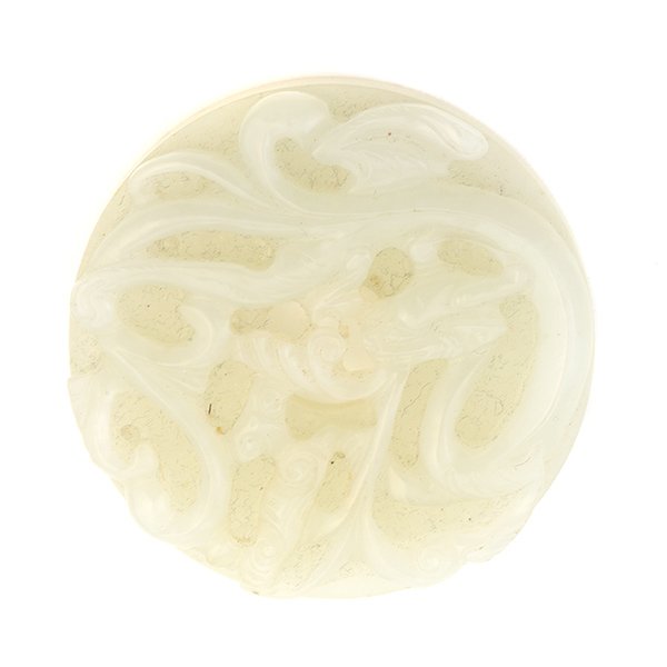 A White Jade Bi Disk, Qing Dynasty: A White Jade Bi Disk With raised bosses to one side, and a coiling dragon with lingzhi branches to the reverse. Qing Dynasty Diameter: 2 3/16 inches (5.5 cm) [Chips]