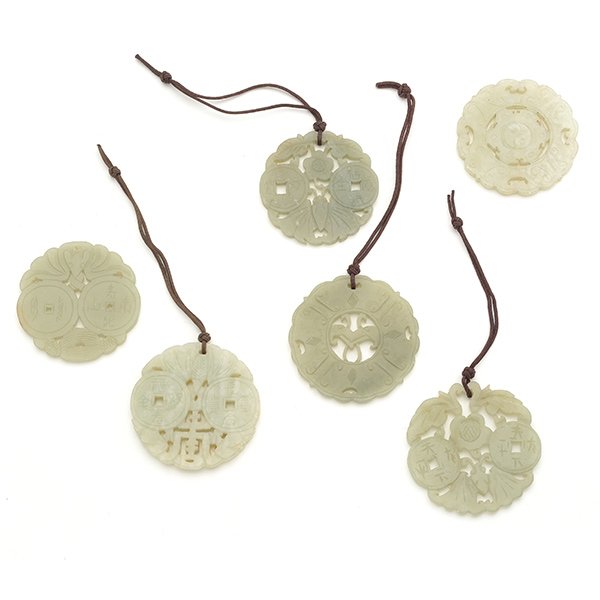 Six Circular Jade Pendants: Six Circular Jade Pendants Including four shaped pendants pierced with a pair of coins and a butterfly to the top, the bottom depicting either a leafy flower, tassels or a longevity character; the rem