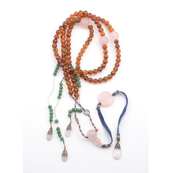An Amber Court Necklace, 19th/20th Century: An Amber Court Necklace Comprising one hundred and eight amber beads of rich honey tone and dark inclusions, interspaced by three large rose quartz beads, centering open drop tassel and three counterw