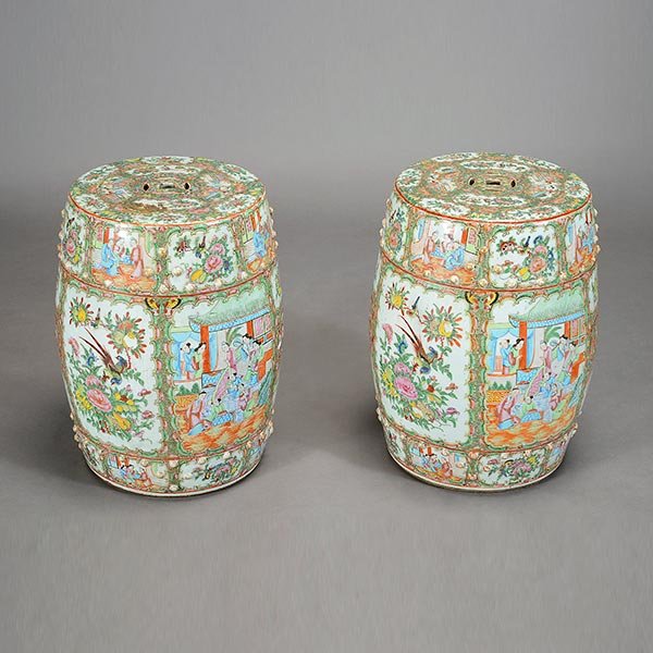 A Pair of Canton Famille Rose Garden Stools, 19th: A Pair of Canton Famille Rose Garden Stools Each of barrel form heavily decorated to the exterior with various reserves depicting figures, flowers and birds, surrounded by colorful floral designs, the