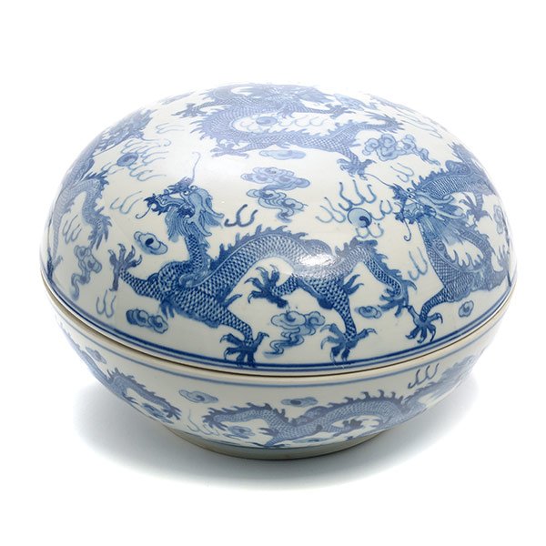 An Underglaze Blue Lidded Container: An Underglaze Blue Lidded Container The circular domed form decorated to the exterior with sinuous dragons flying amidst flames and clouds while in pursuit of flaming pearls, a mark to the base. {Diam