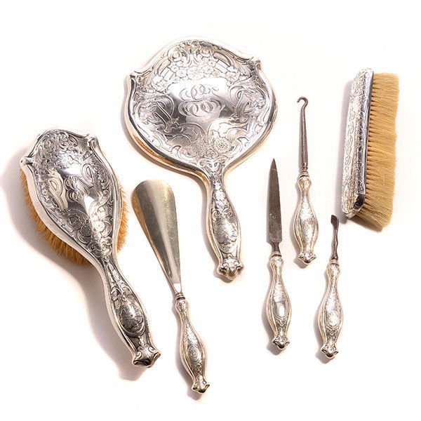 Blackinton Art Nouveau Sterling Dresser Set: Blackinton Art Nouveau Sterling Silver Six Piece Dresser Set: Comprising a hand mirror {length 10 1/4 inches}, hair brush, and four tools; together with an associated sterling clothes brush (7)