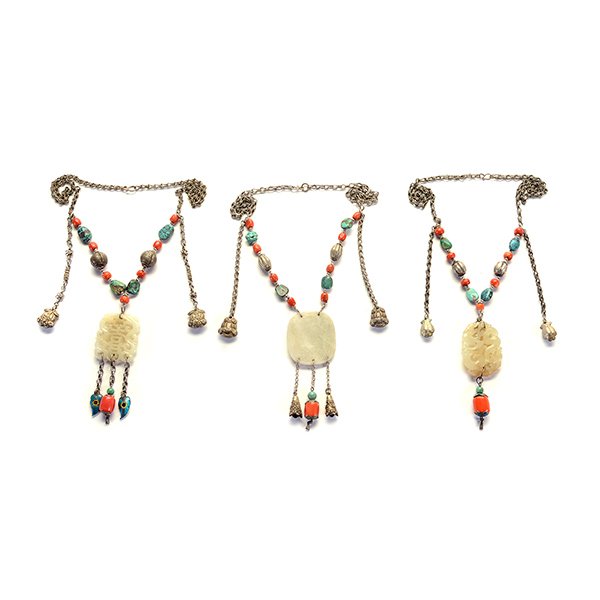 Three Mix Metal Necklaces*: Three Mix Metal Necklaces* Each necklace suspending a carved serpentine pendant and strung with various coral, turquoise and metal beads, further embellished with tasseled ornaments and bells. {Overal