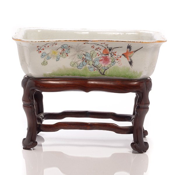 A Famille Rose Jardiniere, Republic Period: A Famille Rose Jardiniere The rectangular vessel painted with a scenes of birds and flowers, inscribed dated to 1937 and signed Wang Peijun, with a fitted wood stand. Republic Period {Length: 9 3/4 in