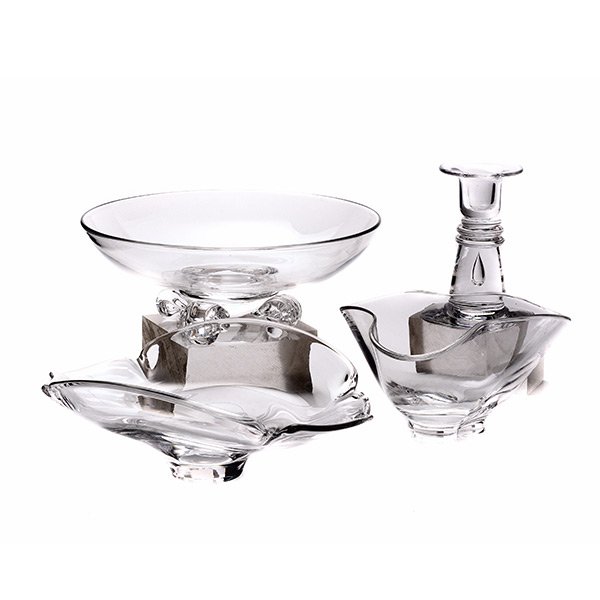 Three Steuben Glass Bowls and A Candlestick: Four Steuben Glass Table Articles: comprising a Calyx bowl, designed by Dennis Polard no. 8115 {length 9 inches}, a bowl with scroll feet, designed by John Drews {diameter 8 1/2 inches}, a Floret bowl