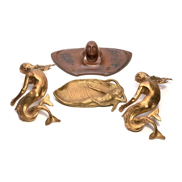Four Art Nouveau Figural Table Articles: Four Art Nouveau Figural Table Articles: Comprising a pair of gilt mermaid mounts {height 9 1/2 inches}, a bronze inkwell cast with woman's face, 35233 {length 10 inches}, and a gilt metal dish with n