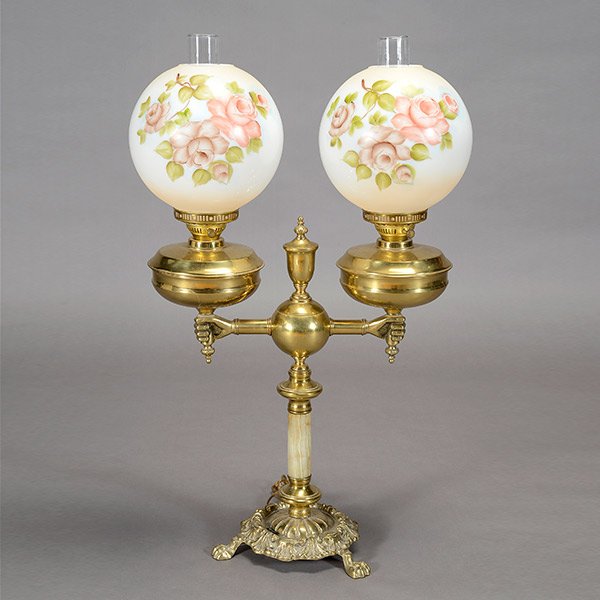 Edwardian Brass Pedestal Form Parlor Lamp: Edwardian Style Brass Pedestal Form Parlor Lamp, with two hand form arms supporting twin electrified lamps, each with shades hand painted with roses {Maximum height 34 1/2 inches; width 20 inches}