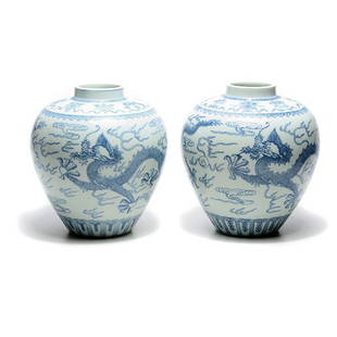 Two Underglaze Blue 'Dragon' Jars: Two Underglaze Blue 'Dragon' Jars Both painted with two sinuous dragons chasing flaming pearls among ruyi scrolls above a ruyi lappet band around the foot, the shoulder displaying the eight Buddhist e