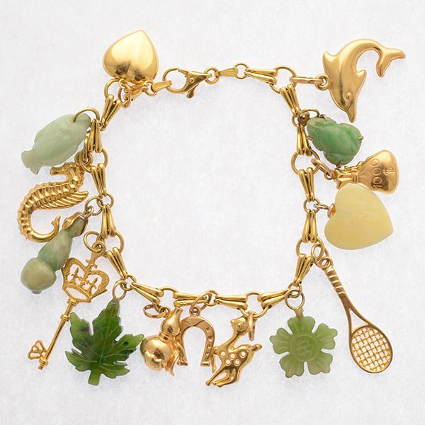 Jade, 14k Yellow Gold Charm Bracelet.: Jade, 14k Yellow Gold Charm Bracelet. The 14k yellow gold fancy link 7 inch chain suspends fifteen charms as follows: five carved jade and bone charms; fish, gourd, maple leaf, flower; frog; nine 14k 