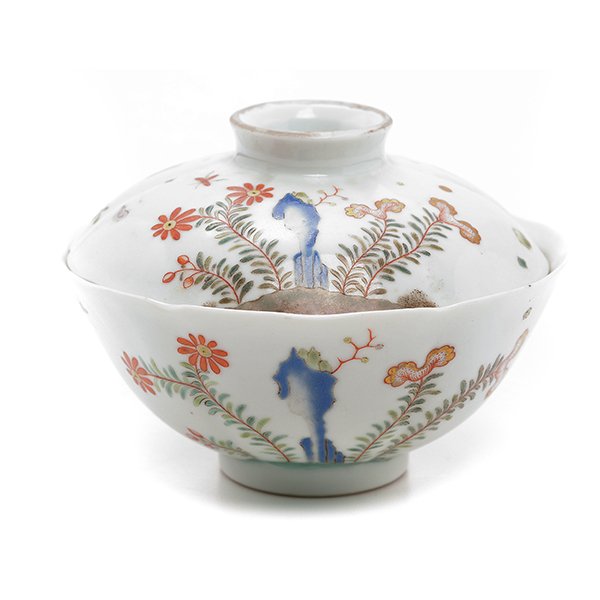 An Enameled Lidded Tea Cup: An Enameled Lidded Tea Cup Painted to the exterior with scattered chickens and chicks amidst various leafy flowers issuing from garden rocks, the interior decorated with iron-red and gilt-painted fish