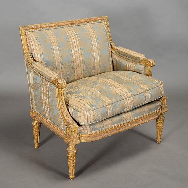 Louis XV Style Gilt Bergere: Louis XV Style Gilt Bergere. The upholstered square back over a trapezoidal shaped seat raised on gilt decorated feather banded stop fluted tapering legs. Dimensions 34 1/2 x 32 1/2 x 22 inches (87.6 
