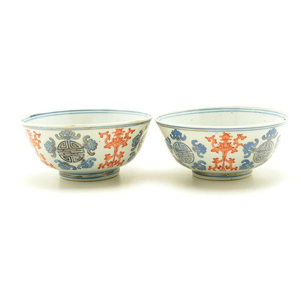 A Pair of Underglaze Blue Bowls, Guangxu Marks/Early: A Pair of Underglaze Blue Bowls Each bowl is painted with bats encircling the longevity character roundels on the interior and exterior, and accented with stylized lotus sprays in iron-red. Guangxu Ma