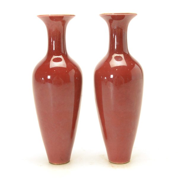 A Pair of Copper-Red Glazed Amphora Vases: A Pair of Copper-Red Glazed Amphora Vases The exteriors covered in a rich red glazed, the interiors witha white crackled glaze. {Height: 9 1/4 inches (23.5 cm) each} [A long hairline crack to one vase