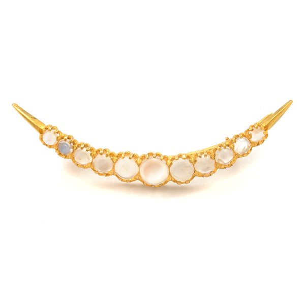 Moonstone, 14k Yellow Gold Brooch.: Moonstone, 14k Yellow Gold Brooch. Featuring eleven moonstone cabochons ranging in size from approximately 5.5 mm to 3 mm, set in a 14k yellow gold crescent shaped mounting measuring approximately 7 x
