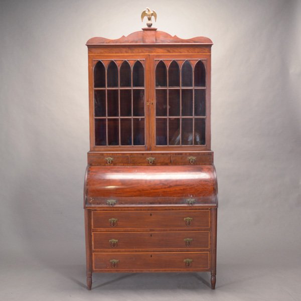 Federal Mahogany Secretary Book Case: Federal Mahogany Secretary Book Case, the top comprising twin gothic mullion glazed doors over a barrel roll top door opening to reveal arrangement of drawers and shelves, surmounted by a brass eagle 