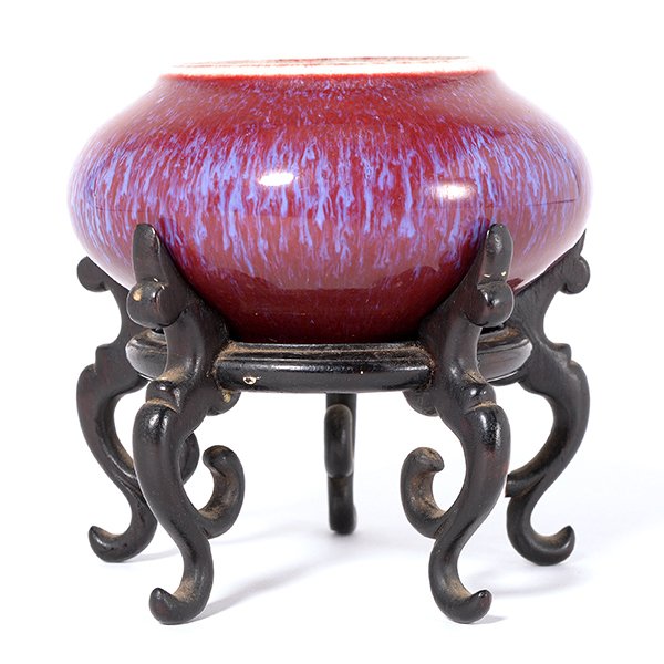 A Flamb Glazed Brush Washer: A Flamb Glazed Brush Washer The thickly potted vessel of bombe form and covered in a rich glaze of deep purplish-red on the exterior and fading to blue on the interior, the brown glazed recessed base 