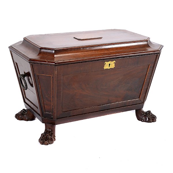 George III Mahogany Wine Cooler: George III Mahogany Wine Cooler. Of casket form, the paneled sides fitted with wreath form loop handles, fitted with a hinged, chamfered lid with raised initialed plaque, opening to a tin lined interi