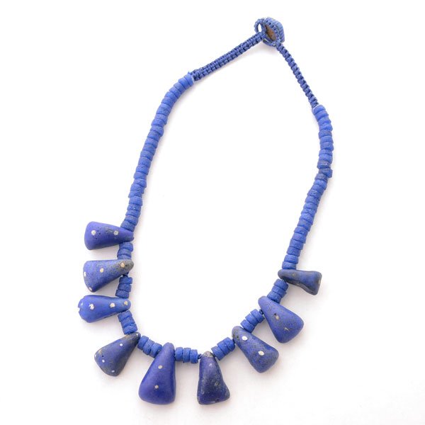 West African Kiffa Bead Necklace.: West African Kiffa Bead Necklace. Composed of nine blue with white dot kiffa beads ranging in size from approximately 28 x 17 mm to 20 x 10 mm, interspersed by blue powder glass beads, completed by a 