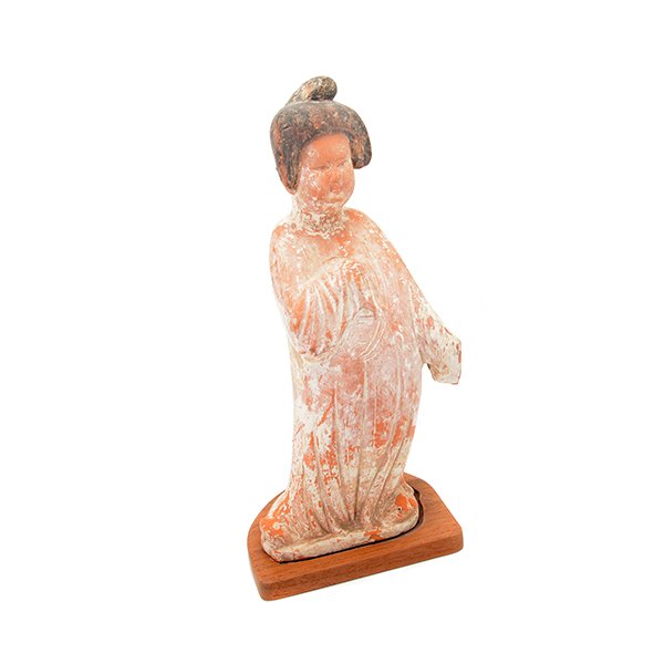 A Red Pottery Figure of a Lady, Tang Dynasty: A Red Pottery Figure of a Lady Shown standing while wearing long draping robes, her hair arranged in a chignon on top of her head, unglazed with traces of color and white slip throughout. Tang Dynasty
