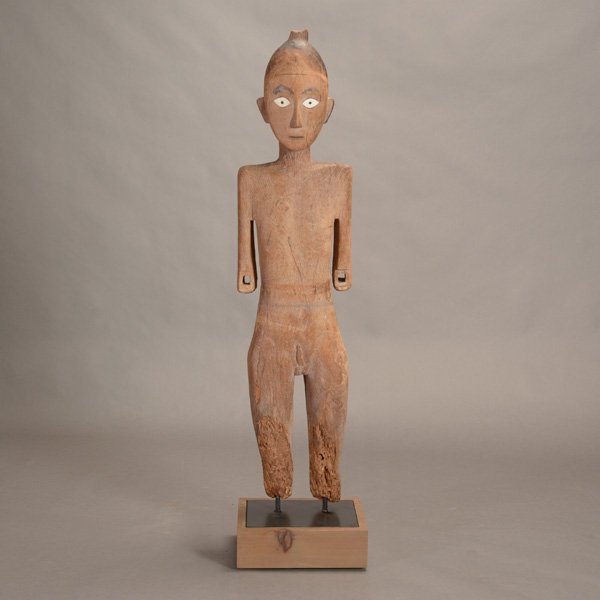 Toraja Carved Wood Tau Tau Figure of a Man, Early 20th: Toraja Carved Wood Tau Tau Figure of a Man, Shown standing with his arms at his side, his face with bone eyes inset with wood pupils, the well defined body carved with genitalia and covered in a raise