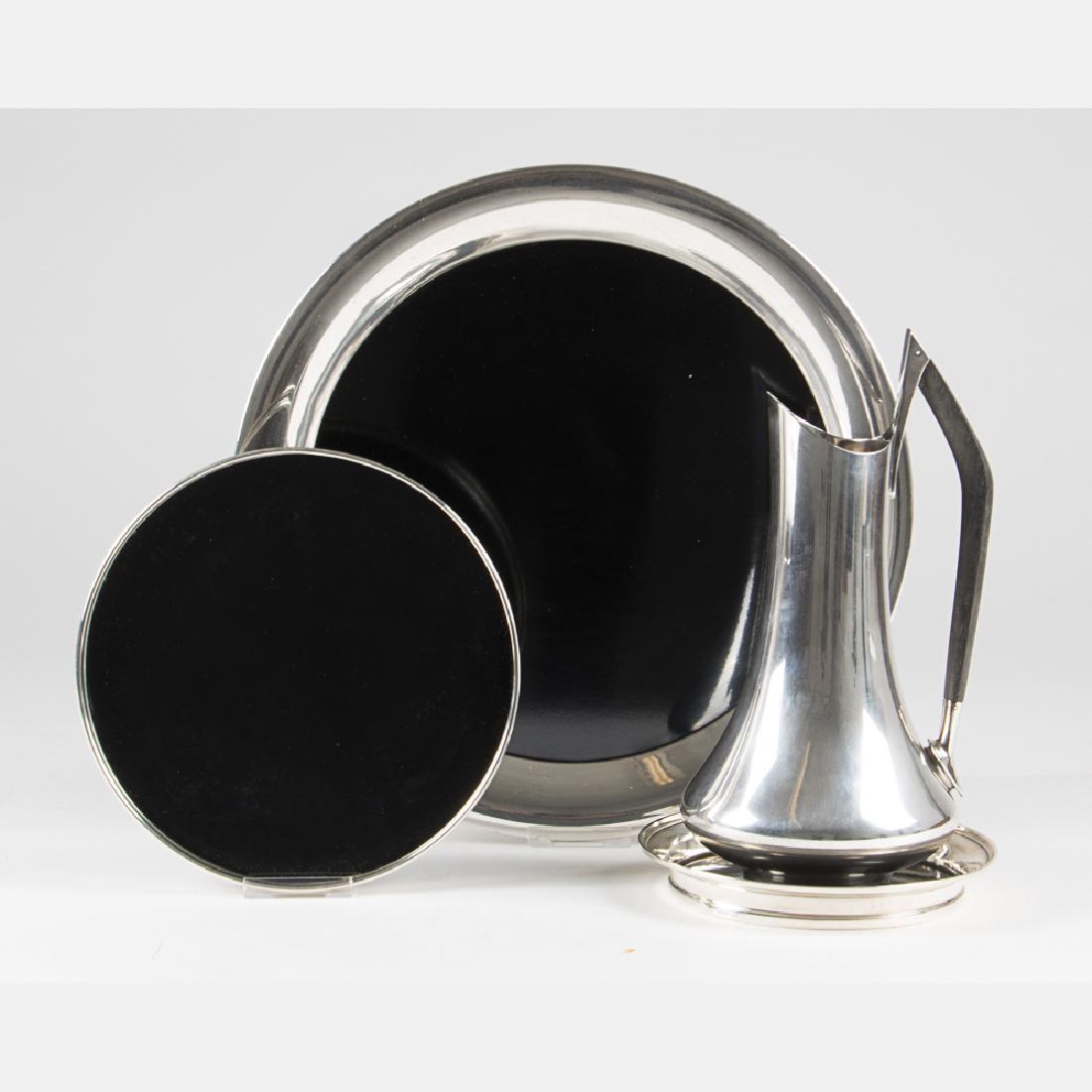A Donald Colflesh for Gorham Sterling Silver and Ebony: A Donald Colflesh for Gorham Sterling Silver and Ebony 3-Pint Pitcher, ca. 1970s, Model number #1460. Together with three sterling silver and laminate circular trays by Reed & Barton, BM, and Gorham.