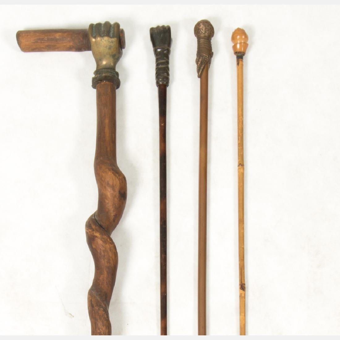 A Group of Three Carved Wood and Metal 'Clenched Fist' (1 of 13)