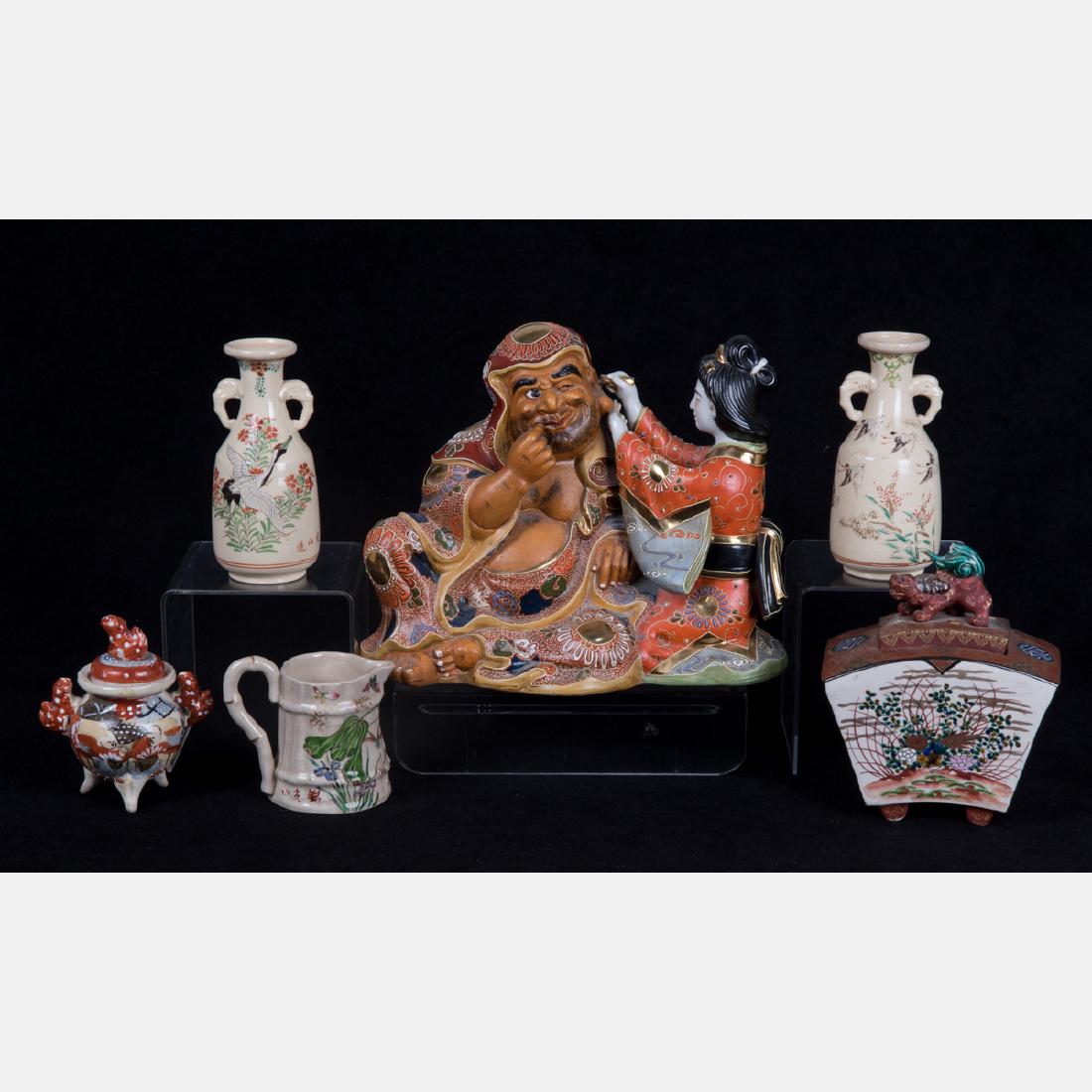 A Group of Japanese Satsuma Style Stoneware Serving and: A Group of Japanese Satsuma Style Stoneware Serving and Decorative Items, 20th Century, Including a pair of vases, creamer, incense box, lidded vessel and figural statuette. Largest dimensions: h: 9 x