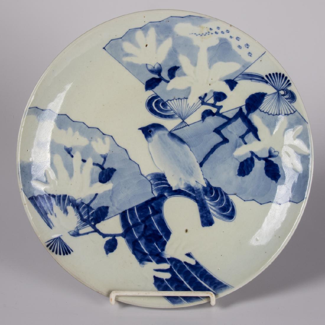 A Japanese Blue and White Porcelain Charger, Meiji: A Japanese Blue and White Porcelain Charger, Meiji Period, Depicting a bird amongst fans. D: 14 7/8 in. The Estate of Ronald J. DiCenzo, Professor of Japanese History, Oberlin College (1972-2005).