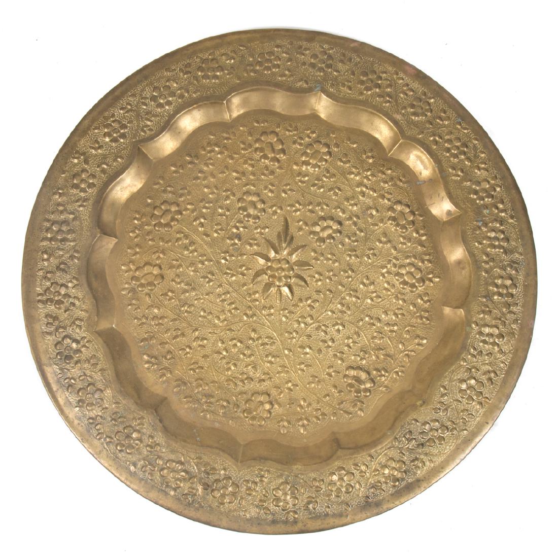 A Persian Repousse Brass Circular Tray, 20th Century. (1 of 3)