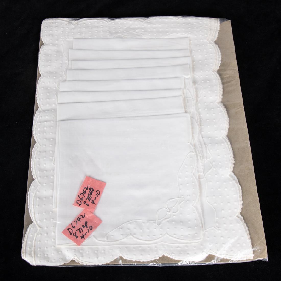 A Set of Sixteen Dotted Swiss Linen Napkins and: A Set of Sixteen Dotted Swiss Linen Napkins and Placemats, 20th Century, Having scalloped edges.