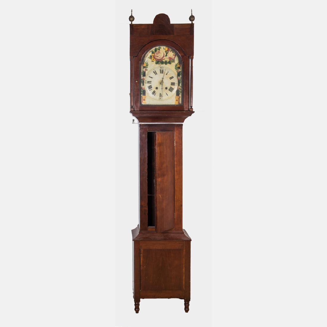 An American Cherry Tall Case Clock with Carved and: An American Cherry Tall Case Clock with Carved and Painted Wood, 19th Century. H: 95 1/2 W: 18 7/8 D: 10 1/2 in. The Estate of Ronald J. DiCenzo, Professor of Japanese History, Oberlin College (1972-2