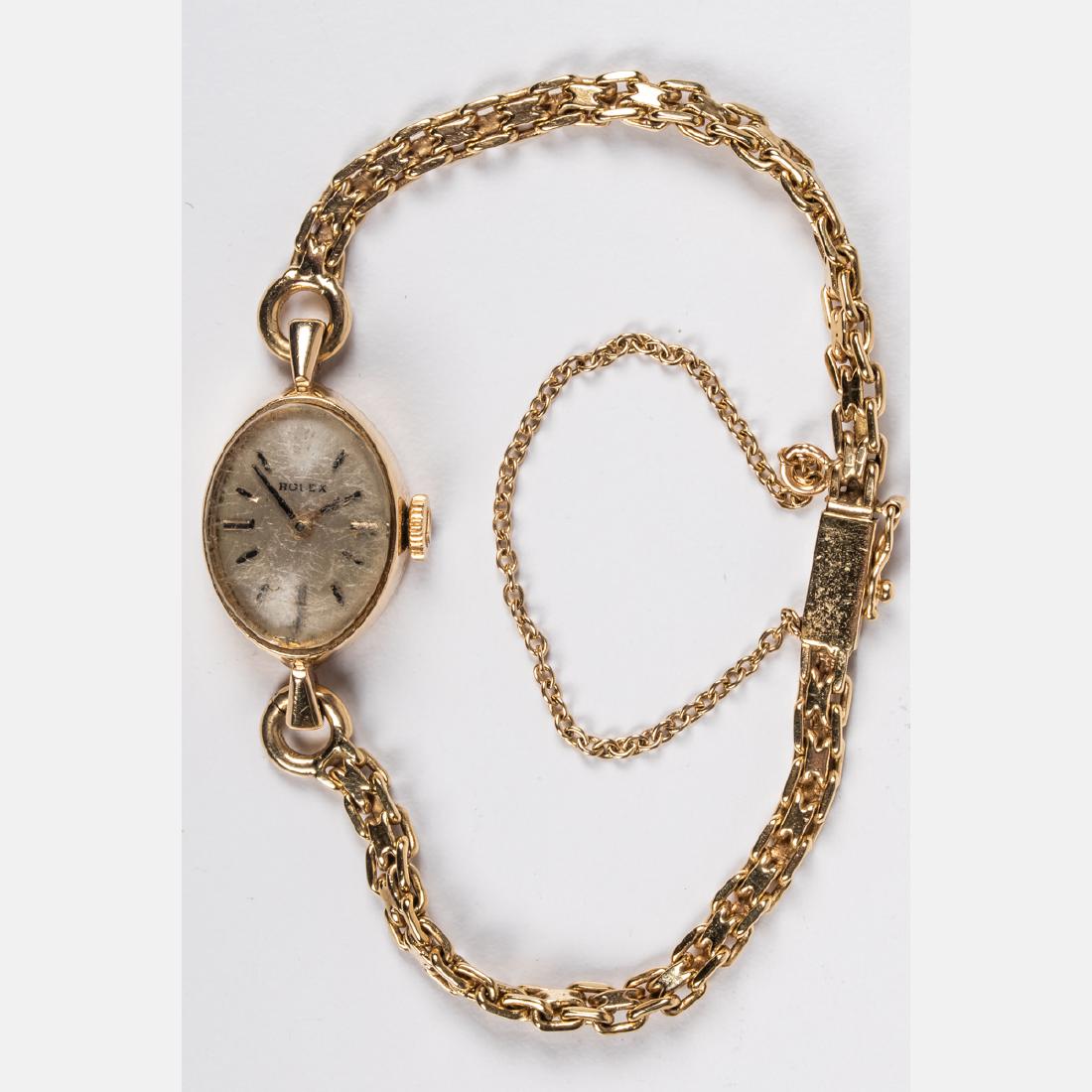 A 14kt. Yellow Gold Ladies Rolex Wrist Watch,: A 14kt. Yellow Gold Ladies Rolex Wrist Watch, Set with a 14kt. yellow gold chain. Total weight: 7.2 dwt.