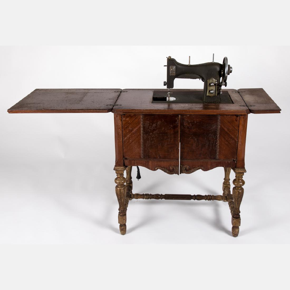 A Vintage Cast Iron and Oak White Rotary Sewing Machine: A Vintage Cast Iron and Oak White Rotary Sewing Machine Table from the Century of Progress World's Fair, Chicago, 1933. H: 30 1/8 W: 27 3/8 D: 18 1/8 in.