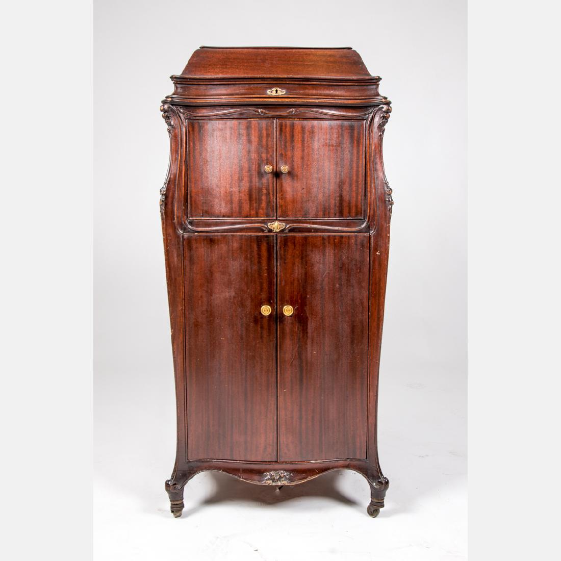 A Vintage Mahogany Electric Victrola Record Player,: A Vintage Mahogany Electric Victrola Record Player, 20th Century, Having a collection of seventy-eight records. H: 47 W: 24 D: 22 in.