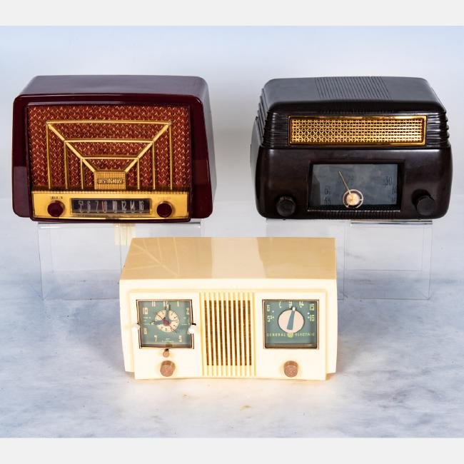 A Group of Three Bakelite and Plastic Radios by Various: A Group of Three Bakelite and Plastic Radios by Various Makers, 20th Century,Including two by General Electric (a brown no. 202 and cream clock radio) and a maroon Westinghouse Radio no. 327-T6.Larges