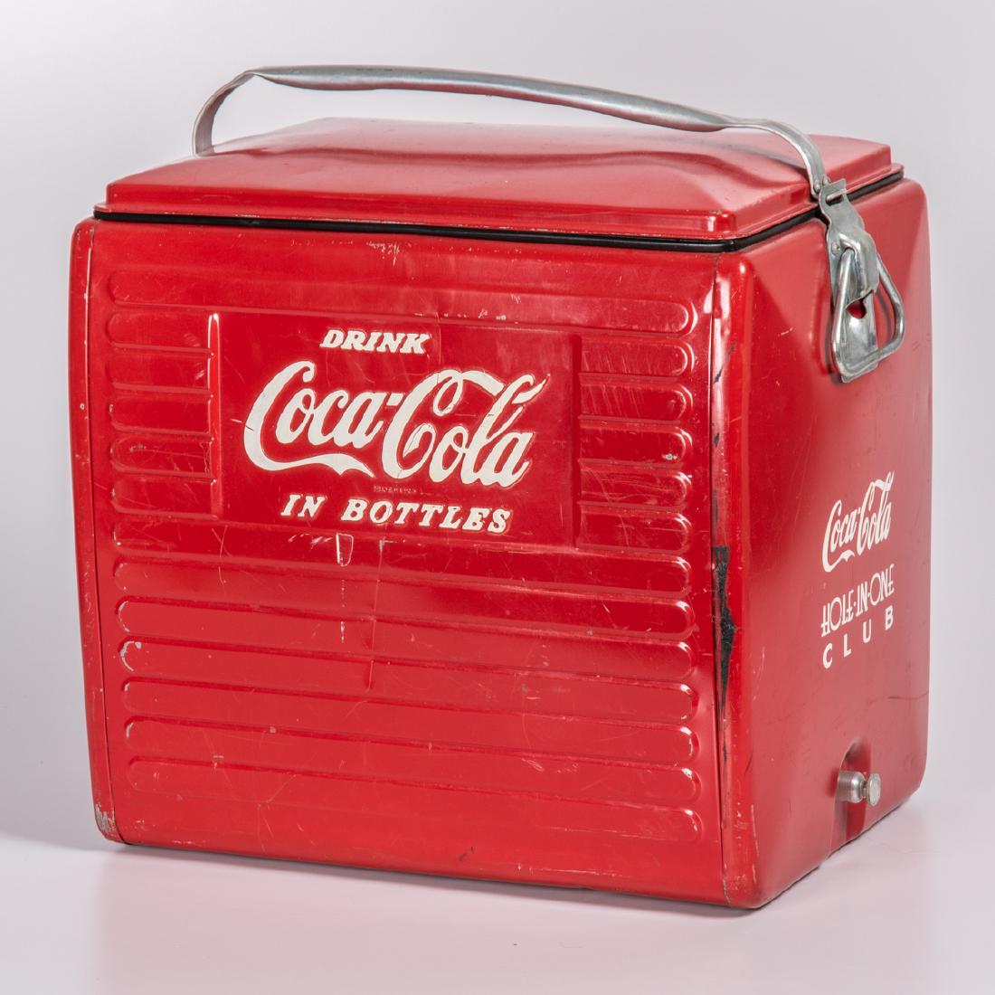 A Vintage Painted Metal Coca-Cola Cooler from the: A Vintage Painted Metal Coca-Cola Cooler from the Hole-in-One Club by the Acton Mfg. Co. Inc., 20th Century. Having an aluminum insert. H: 19 W: 18 1/2 D: 12 in.