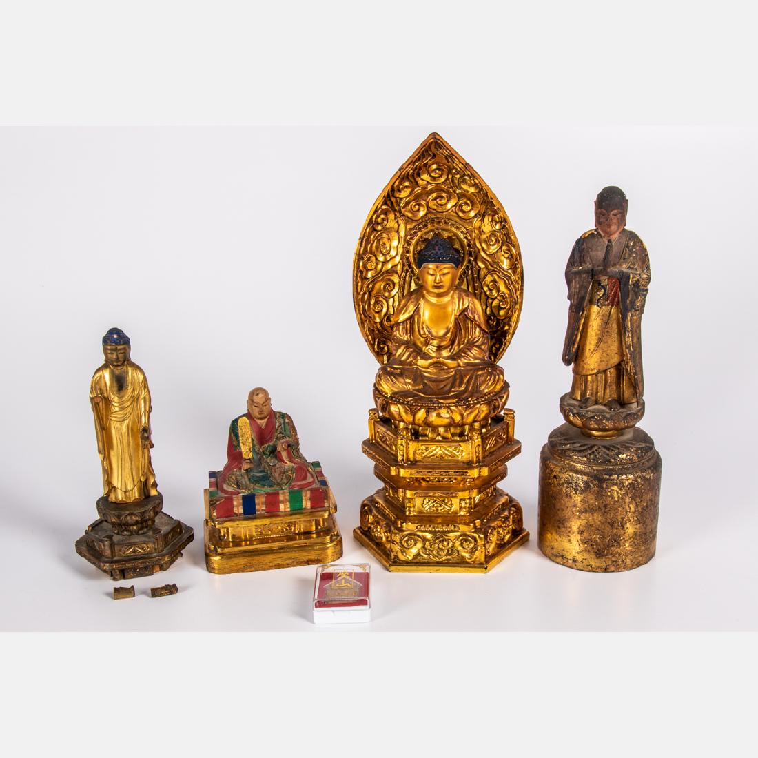 A Group of Four Asian Carved. Polychrome and Gilt: A Group of Four Asian Carved. Polychrome and Gilt Painted Wood Buddha Statues, 20th Century, Together with a Thai Buddhist amulet. Largest dimensions: h: 12 1/8 x w: 5 1/2 x d: 3 5/8 in.