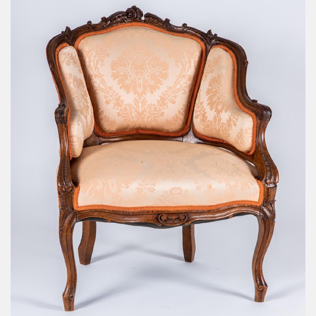 A French Provincial Style Carved Mahogany and Silk: A French Provincial Style Carved Mahogany and Silk Upholstered Bergère, 20th Century. H: 33 W: 26 D: 23 in.