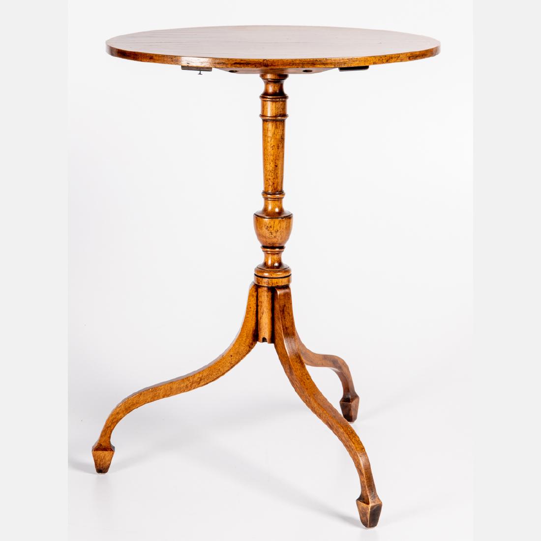 A Georgian Style Tea Table, 20th Century,: A Georgian Style Tea Table, 20th Century, Having an oval banded top over the turned standard raised on tripod base. H: 22 W: 16 1/2 D: 13 in.