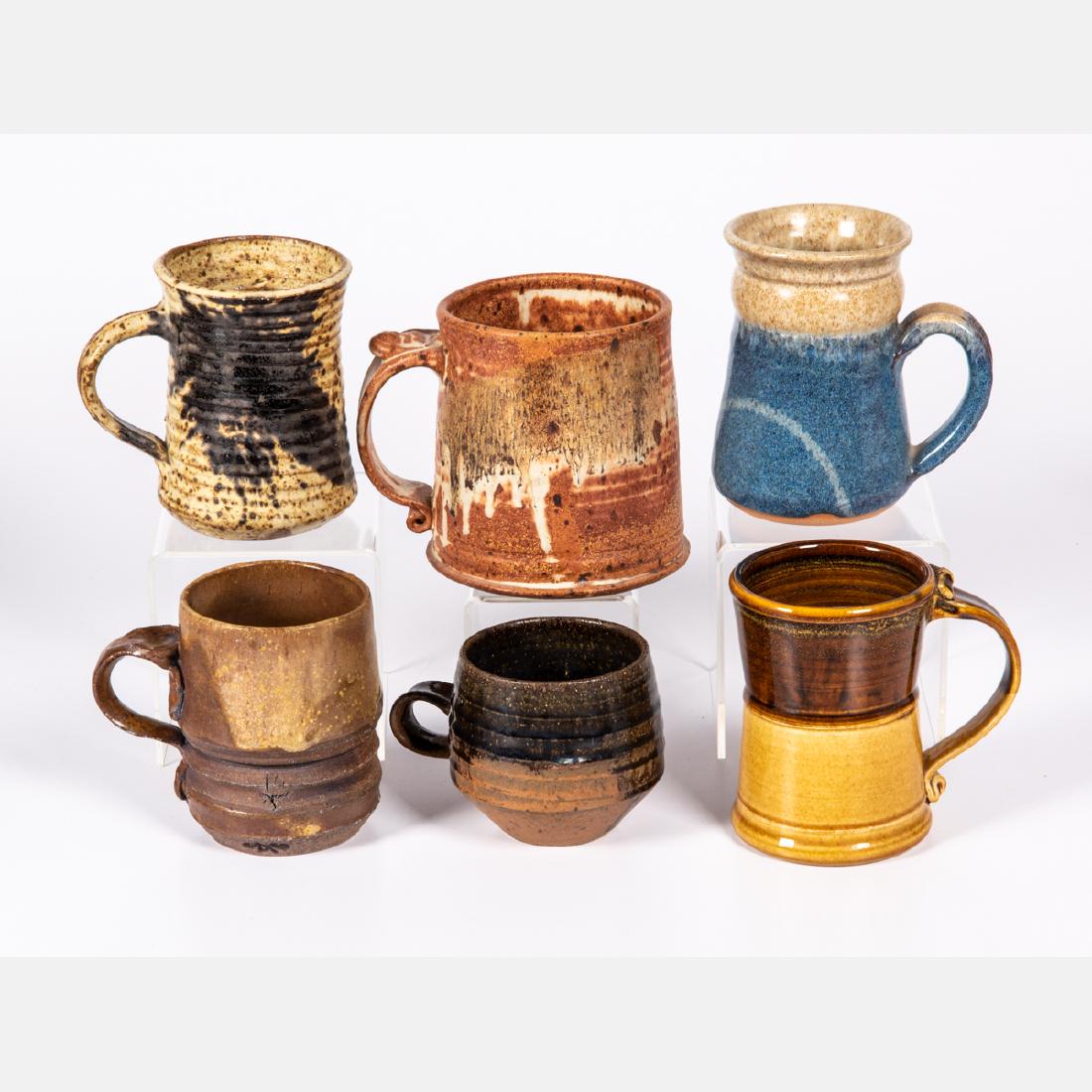 A Group of Six Glazed Stoneware and Earthenware Mugs by: A Group of Six Glazed Stoneware and Earthenware Mugs by Various Artists, 20th Century, Including a pieces by Hart, Burle and possibly some by George Roby. Largest dimensions: h: 4 7/8 x w: 5 7/8 x d: 