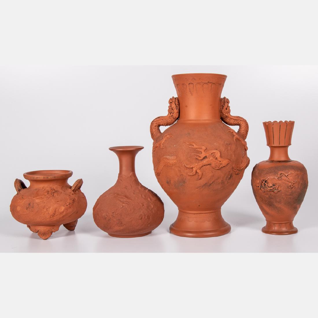 A Group of Four Japanese Tokoname Redware Vases with: A Group of Four Japanese Tokoname Redware Vases with Dragon Form Decoration, 20th Century, One with dragon form handles, three are signed on bottom. Largest dimensions: h: 12 in.