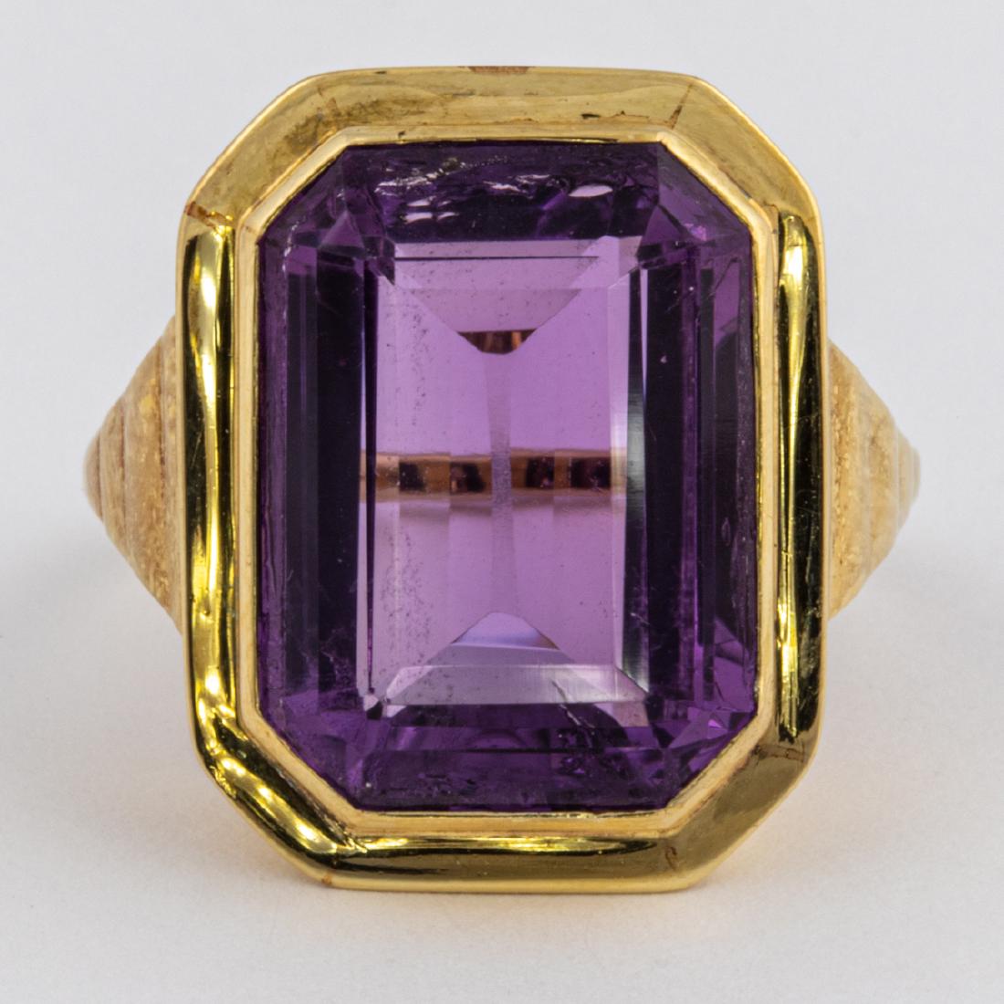 An 18kt. Yellow Gold and Amethyst Ring,: An 18kt. Yellow Gold and Amethyst Ring, Set with one emerald cut amethyst, approx. 16mm. x 12mm. Unmarked. Ring size: 6. Total approx. weight: 4 dwt. Please note no credit card payments for first time