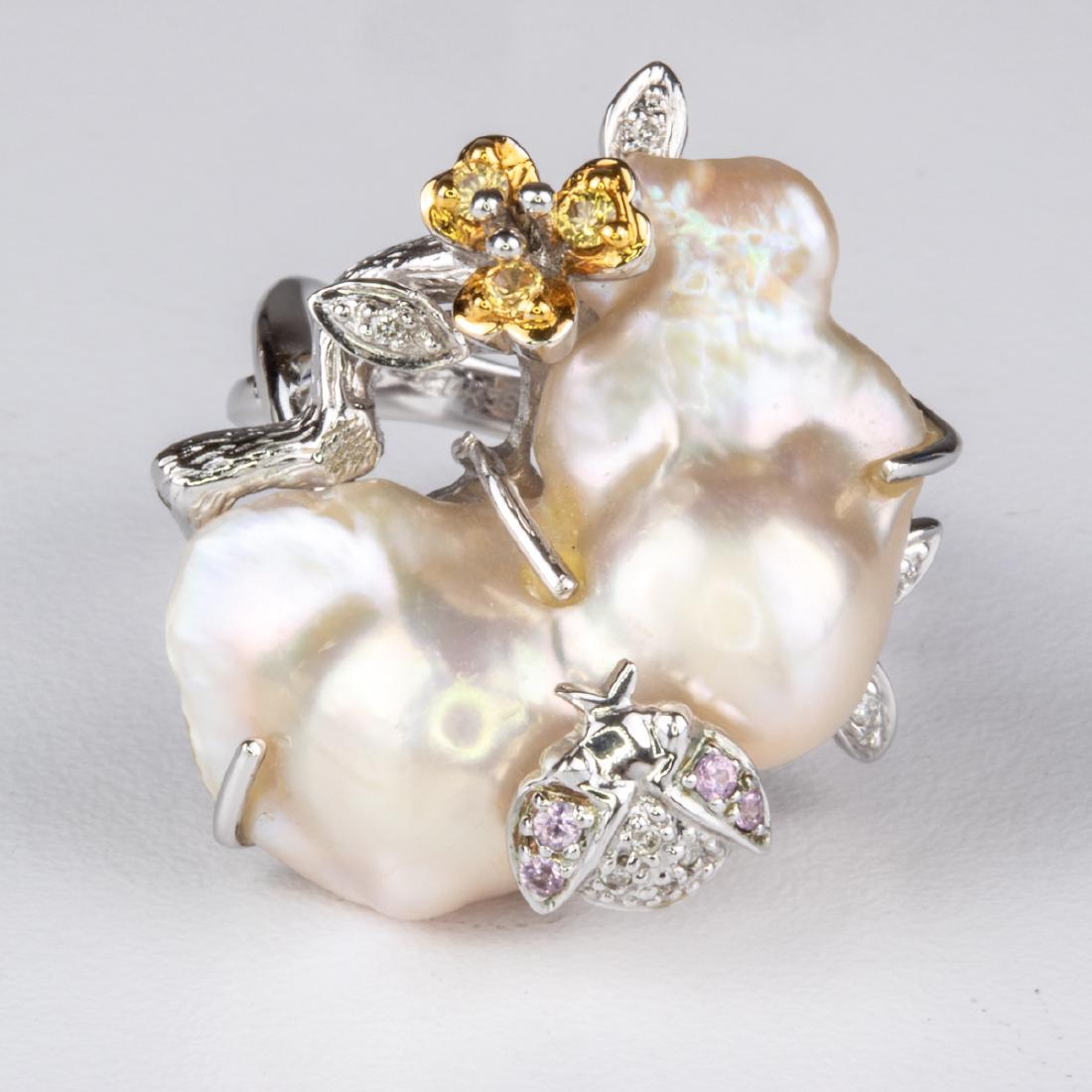 A 14kt. White Gold, Baroque Pearl and Colored Stone: A 14kt. White Gold, Baroque Pearl and Colored Stone Ring, Set with clear, yellow and pink stones, each approx. 0.01pts. Pearl measures 25.61mm. x 12.73mm. Marked 14k., 585, DC. Ring size: 6 1/2. Total