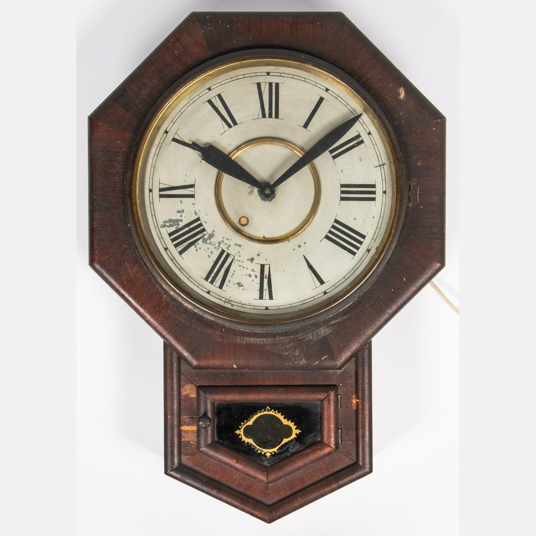 An Electrified New Haven Clock Company (Connecticut) 12: An Electrified New Haven Clock Company (Connecticut) 12 in. Octagon Wall Clock, 20th Century. H: 24 W: 4 D: 17 in.